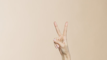 Female hands with victory sign