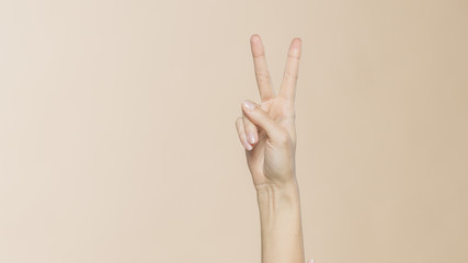 Female hand pointing Victory sign