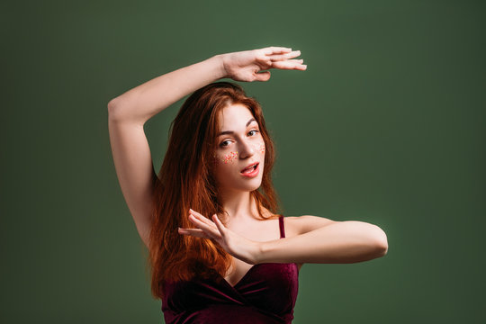 Young woman portrait. Youth beauty. Beautiful redhead female making frame gesture.