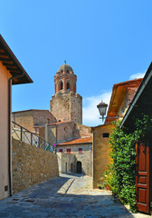 Obraz premium Narrow stone street with Old Rocchette fortress in Castiglione della Pescaia. It is an ancient seaside town and in Grosseto province. Tuscany Italy