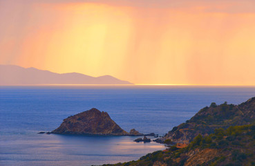 Ray of lights on mediterranian sea in tuscany countryside, nature and scenic aerial view of blue sea against cloudy sky. From Island on background. Monte Argentario (Grosseto). Tuscany. Italy