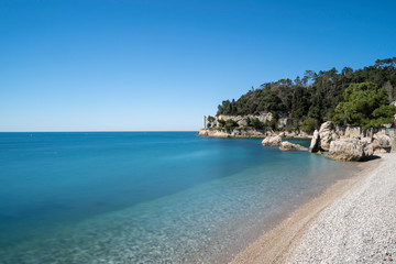 Beautiful sunny rocky beach in Miramare's park, Trieste Italy