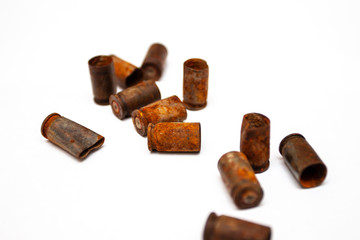 A pile bullet shells on a white background