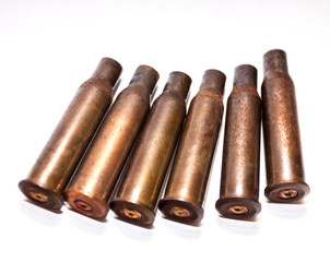 A pile bullet shells on a white background