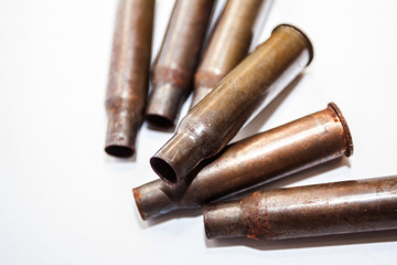 A pile bullet shells on a white background