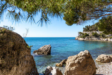 Fototapeta premium Beautiful sunny rocky beach in Miramare's park, Trieste Italy