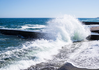 Sea waves on the beach, bright blue water