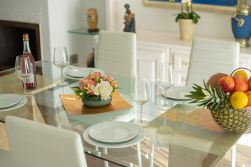 glass table setting with flower arrangement and fruit