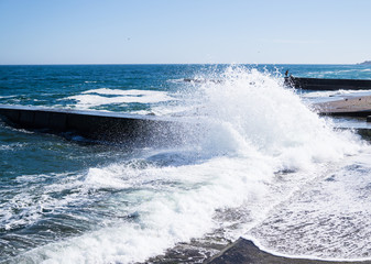 Sea waves on the beach, bright blue water