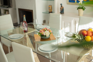 glass table setting with flower arrangement and fruit