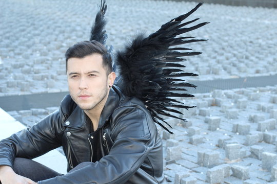 Cute ethnic angel with black wings 