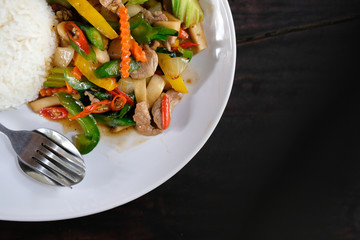 stir fry vegetable mushroom & pork with rice. green yellow bell pepper carrot