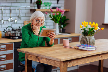 Joyful madam delighting in relatives portrait spending time at kitchen