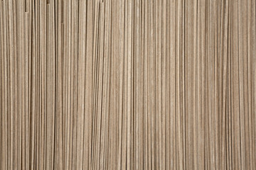 Dried buckwheat soba noodles background, top view. Flat lay, overhead.