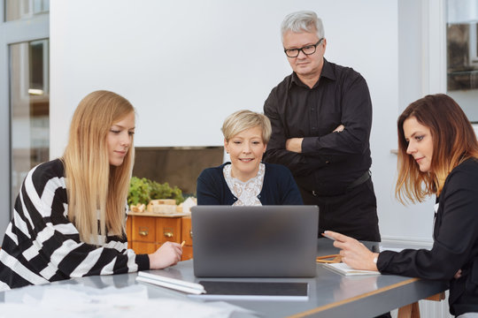 Group of businesswomen and a man in a meeting