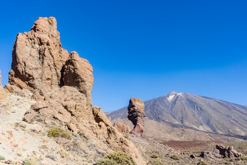 Rock formations in the foreground and the volcano El Teide in the background on the island of Tenerife, Spain (landscape)