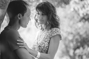 Happy couple on vacation. Happy guy and girl. Lovers enjoy each other in the evening park.