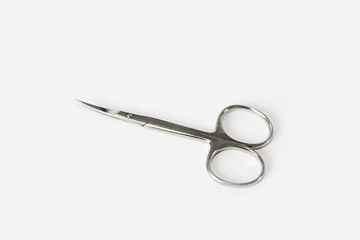 metallic silver manicure sharp scissors on a white background
