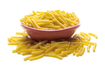 Macaroni, raw pasta in bowl isolated on white background