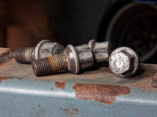 Four rusty wheel bolts