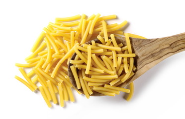 Macaroni, raw pasta with wooden spoon isolated on white background, top view