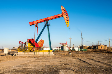 Fototapeta na wymiar Oil pumps are running at the oil field. On the Bohai coast of China.