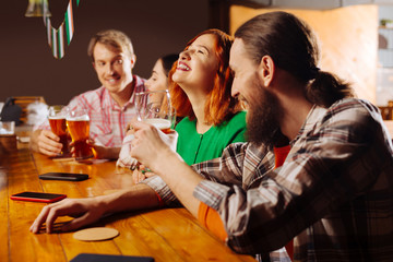 Four colleagues spending Friday night in the pub drinking beer