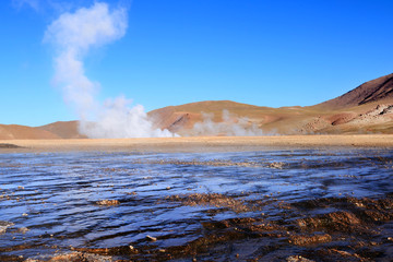 Geysers El Tatio - river with geyser in the background