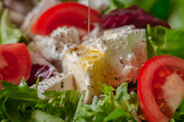spring fitness salad. lettuce, radicio, tomatoes, and feta cheese with olive oil