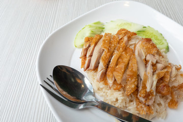 Fried chicken rice, placed on a white plate, should be considered a food and health concept. with copy space.