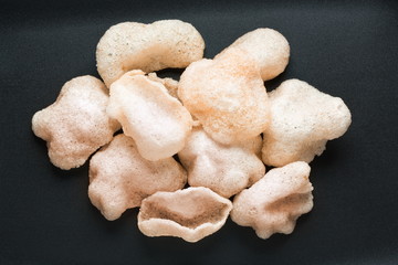 Shrimp chips top view on a white background. Prawn cracker krupuk top view.