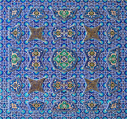 Ceramic mosaic pattern.Colorful floral background. Ceramic mosaic close up. Vietnamese ceramic floor. Dirty floral floor fragment photo. Contrast. Tile