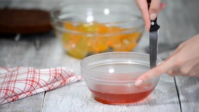Cutting red jelly into pieces.