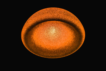 Abstract glowing ball on black background. Unusual glowing object. Abstract background.