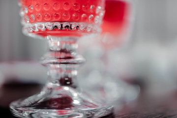 Beautiful crystal drinking glass closeup. Alcohol concept with blurred background.