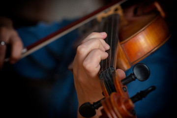 Fototapeta premium Violin player violinist classical music playing. Orchestra musical instruments