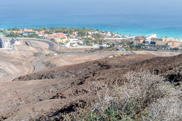 Fototapeta na wymiar Arid landscape of Fuerteventura with resorts on the coast