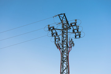High voltage power tower pylon and line cables.