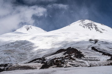 Amazing perspective of caucasian snow mountain or volcano Elbrus with blue sky background.