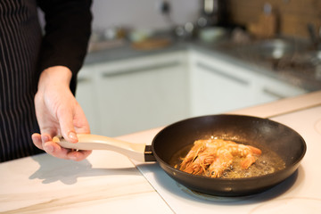 fried in butter with sesame seeds shrimp in a pan
