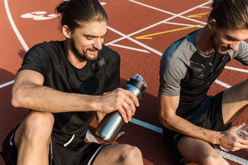 Two twin brothers resting after workout