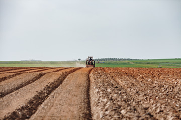Obraz premium Tractor Plowing Field