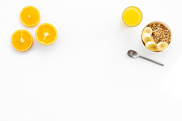 Bright breakfast with granola and orange juice on white background top view mockup