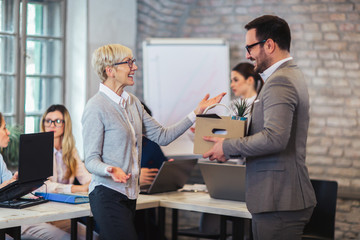 Smiling team leader executive introducing new just hired male employee to colleagues.