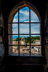 Fototapeta na wymiar The small picturesque town Sirmione by the Lake Garda in Italy framed in a window