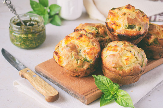 Freshly baked muffins with spinach, sweet potatoes and feta cheese on white background. Healthy food concept. Savory pastry.