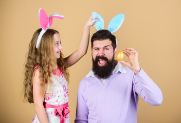 Holiday bunny long ears. Family tradition concept. Family dad and daughter wear bunny ears. Father and child celebrate easter. Spring holiday. Easter day. Easter activities for children. Happy easter