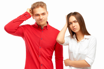 Attractive trendy young business people looking away with confused disappointed expression, scratching head, on isolated white background. Handsome entrepreneurs not remembers information on  project