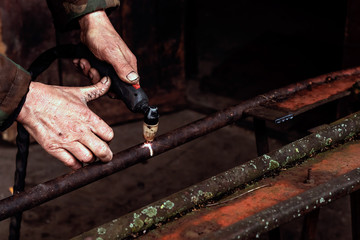 Cutting steel with plasma. Male welder cuts metal plasma.