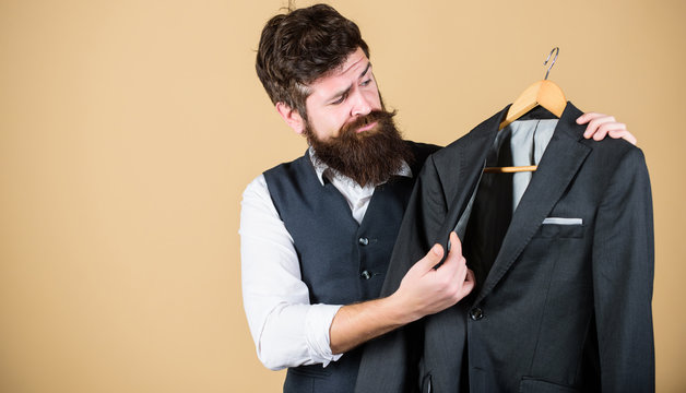 This Coat Designed For Everyday Casual Wear. Bearded Man Thinking What To Wear For Business Casual Event. Businessman Holding Suit Jacket For Casual Dress Code. Dress Code Is Business Casual